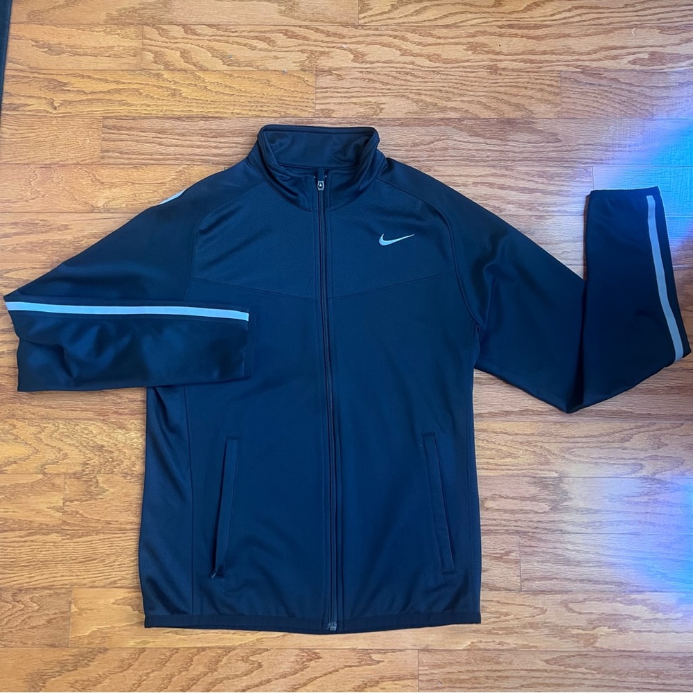 Nike mens black zipper jacket with gray stripe and front pockets.